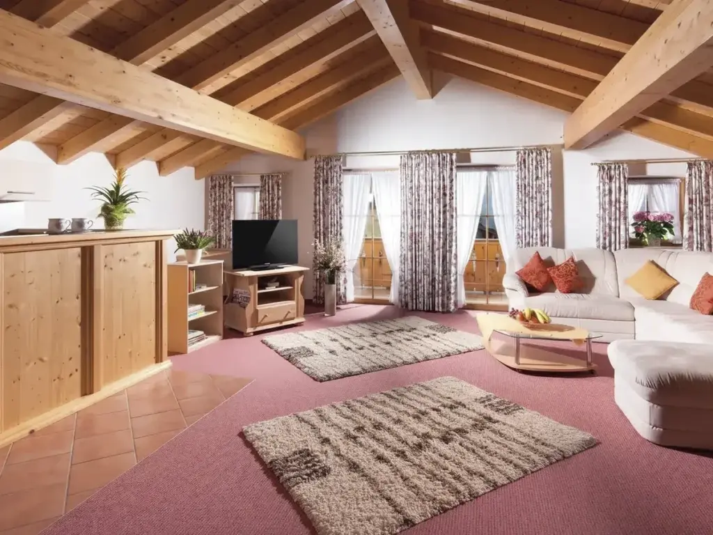 Wohnbereich einer Ferienwohnung mit Holzdecke und Küchenzeile